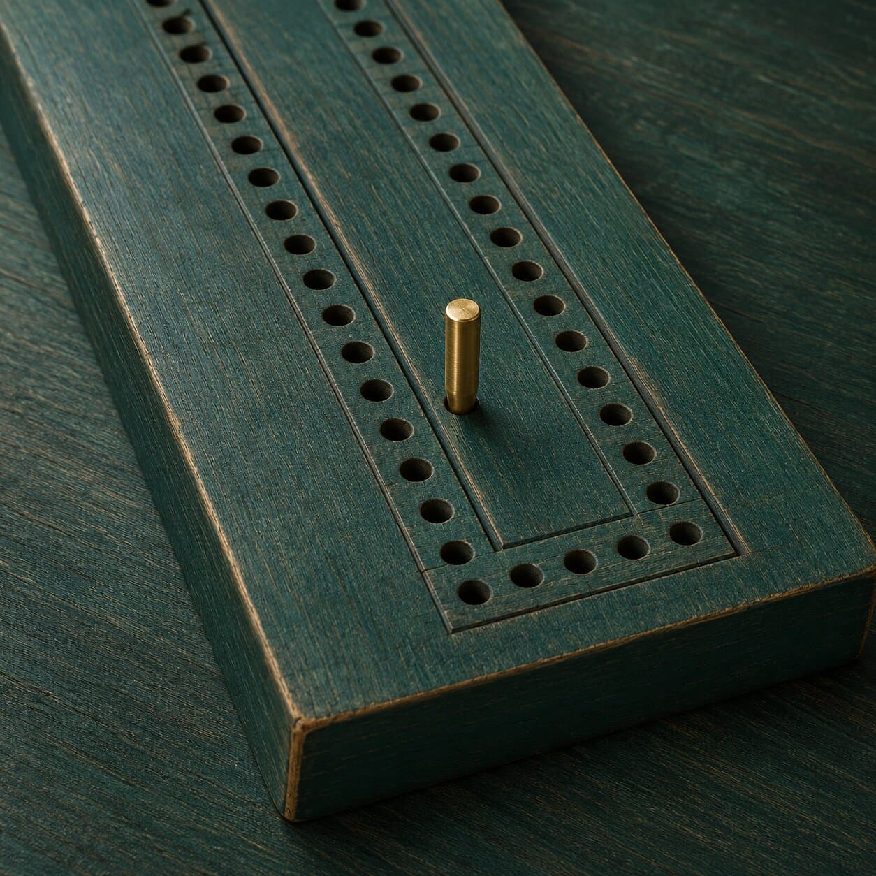 The app icon: a worn green wooden cribbage board with a single brass peg.